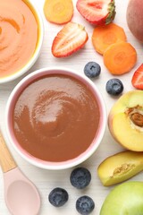 Baby food. Tasty puree in bowls and different ingredients on white wooden table, flat lay