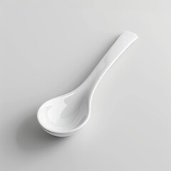 A white ceramic spoon designed for serving or tasting food. on white background