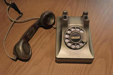 Old fashioned telephone in gold. A close-up of a vintage telephone made in rusty metal....