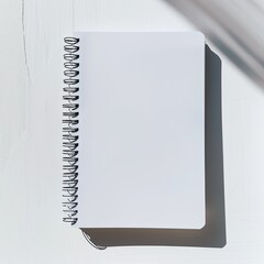 A blank spiral notebook resting on a surface, ready for notes or sketches. on white background