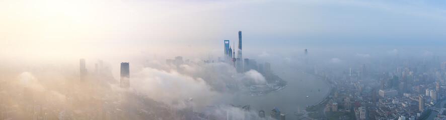 Aerial view of Shanghai skyline with heavy fog at sunrise.