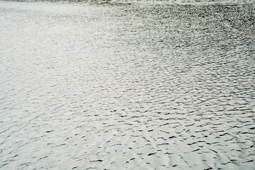 The water is calm and still, with no ripples or waves