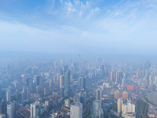 Aerial view of Shanghai skyline with heavy fog at sunrise.
