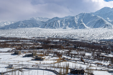 Aerial View of Snowy Ladakh Valley with Villages and Himalayan Mountains