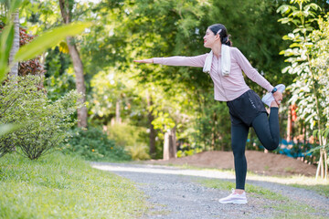 Woman doing yoga in a green park, promoting fitness and relaxation in nature.