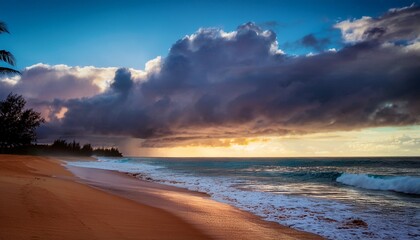 early morning at the beach in kauai hawaii united states the pacific ocean with rain clouds as the sun rises