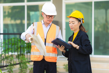 two architects looking at blueprint