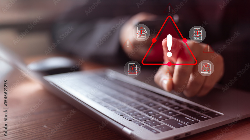 Poster cybersecurity warning concept with user pointing at a red alert icon on a laptop. data breach risk,