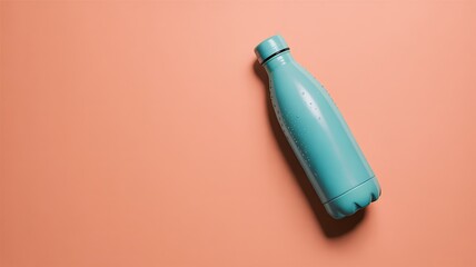 Aqua blue water bottle on coral background