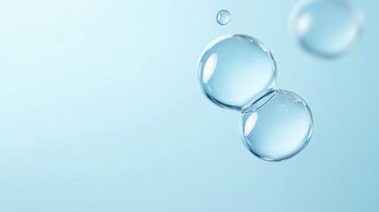 Close-up view of translucent spherical water bubbles in various sizes against a soft light blue background creating an ethereal and tranquil atmosphere
