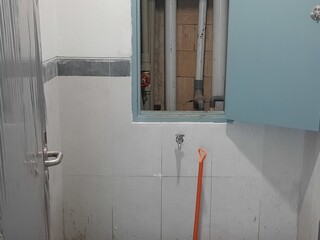 Toilet renovation project showing half-installed plumbing and marked repair zones, ideal for home...