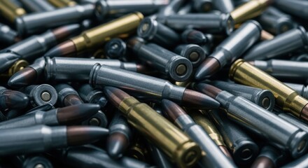 Close up view of a large pile of silver and brass rifle ammunition cartridges