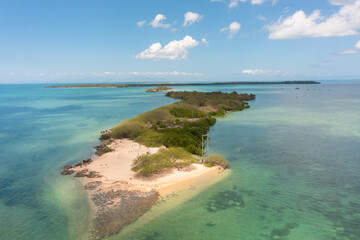 Island surrounded by coral reefs. Sandy beaches in Bantayan, Cebu. Boat running on water. Philippines.