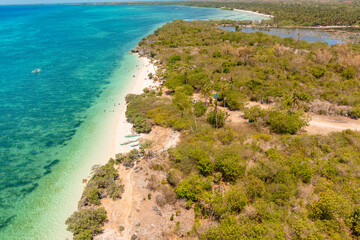 Clear water and white sands in Sandira Beach. Corals and blue sea in Bantayan Island. Cebu,...