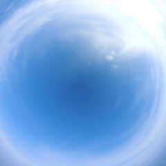 Wide-angle view of the sky featuring blue tones and cloud patterns