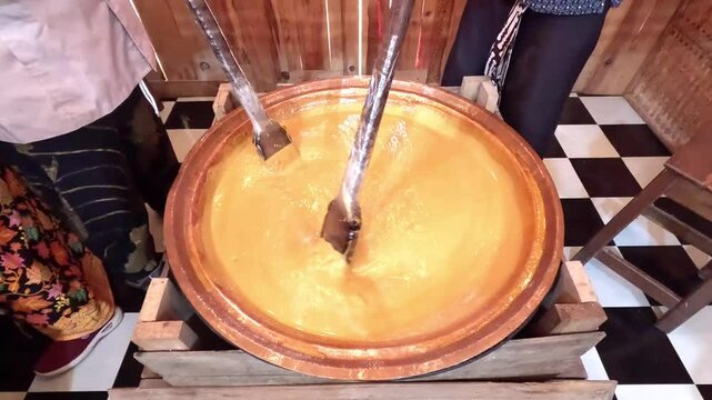 The process of making jenang. Jenang is an Indonesian traditional snack made from a mixture of glutenous rice, brown sugar and coconut milk.