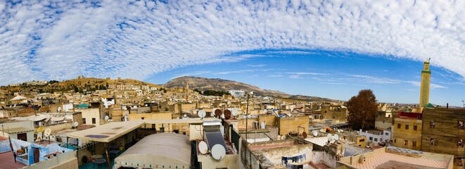 North African city rooftops, satellite dishes, and laundry.