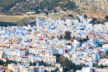 Densely populated hillside town, colorful buildings.