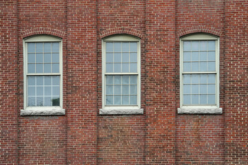 facade view of old factory building with red brick wall