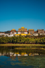 Songzanlin Monastery Reflecting in a Tranquil Lake in Shangri la