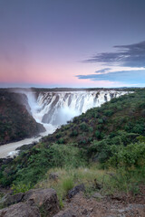 Ruacana Falls under a pastel Sky.