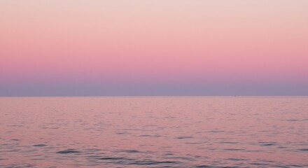 Obraz premium Pink and Purple Sunset Over Calm Ocean