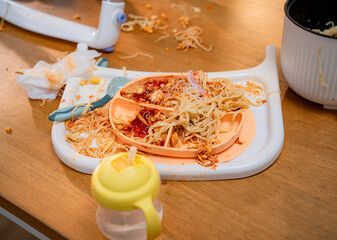 Messy meal time with spilled food and clutter on the table during a family gathering