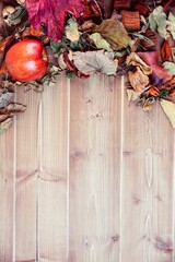 Overhead view of apple and leaves on table