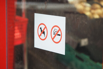 No dogs and no smoking signs on a store door