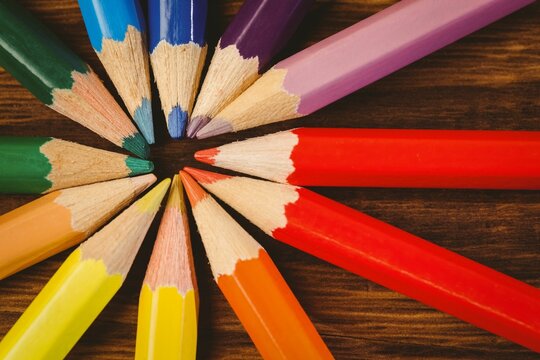 Color pencils arranged on wooden table