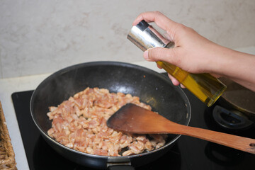 Cooking diced meat in a frying pan on the stove