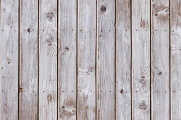 Vertical weathered planks are forming full-frame flat design showing grain and nail holes
