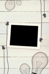 Tablet and plugs on wooden background