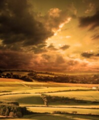 Fields against cloudy sky