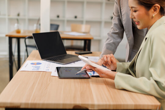 Team of confident business people point to graphs and charts to analyze market data, investor working start up project for strategy plan with document.
