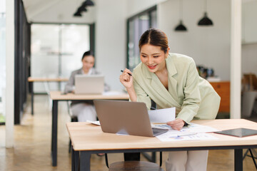 Shot of a asian business female working on laptop computer in her workstation.Portrait of Business people employee freelance online marketing e-commerce telemarketing concept.	