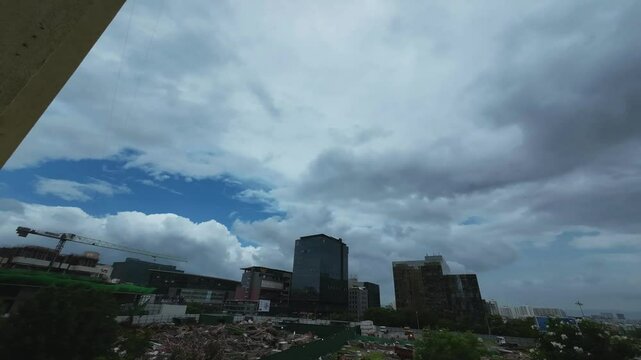 Time lapse video of an early morning scene with buildings and a cloudy sky during the monsoons at Pune India.
