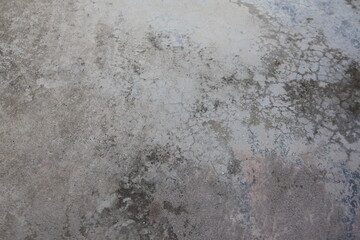 Close-up of a worn, cracked concrete floor surface