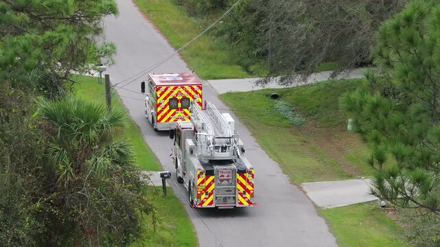 Drone view of fire truck responding to emergency on Florida roadway, showing emergency lighting and service insignia.