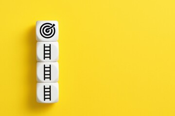 White dice with ladder and target on a bright yellow background