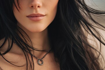 A woman with long black hair wearing a necklace