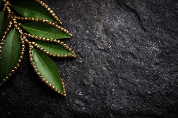 A bunch of green leaves on a black surface