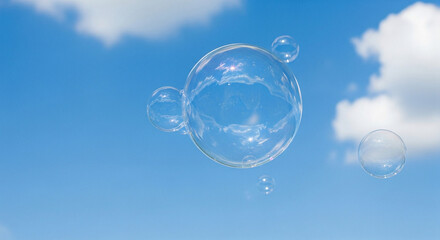 Soap bubbles floating in clear blue sky.