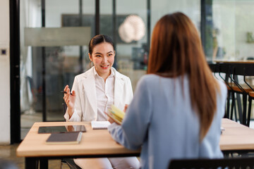 Team of confident business people point to graphs and charts to analyze market data, balance sheet, account, net profit to plan new sales strategies to increase production capacity.	