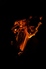 Fire flames on black background. Closeup of fire flames isolated on black background