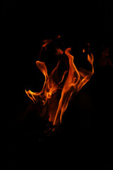Fire flames on black background. Closeup of fire flames isolated on black background