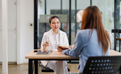 Team of confident business people point to graphs and charts to analyze market data, balance sheet, account, net profit to plan new sales strategies to increase production capacity.	