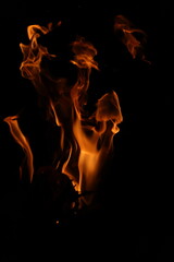 Fire flames on black background. Closeup of fire flames isolated on black background