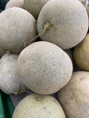 Close up of cantaloupe skin showcasing intricate, organic textures, perfect for natural-themed backgrounds, packaging, and digital pattern references.