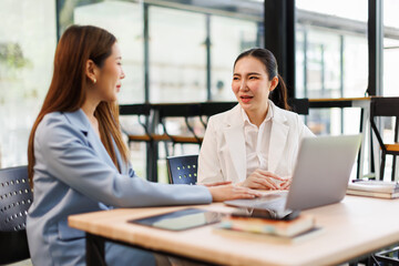 Financial analysts analyze business financial reports on a digital tablet planning investment project during a discussion at a meeting of corporate showing the results of their successful teamwork.	